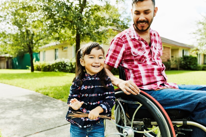 Daughter with father in wheelchair